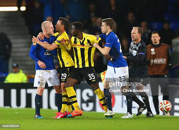 Steven Naismith of Everton is held back by Raphael Nuzzolo of BSC Young Boys as he clashes with Sekou Sanogo Junior of BSC Young Boys, who is held...