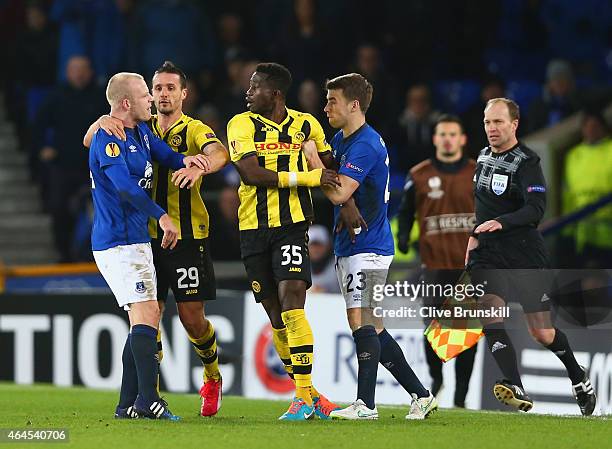 Steven Naismith of Everton is held back by Raphael Nuzzolo of BSC Young Boys as he clashes with Sekou Sanogo Junior of BSC Young Boys, who is held...