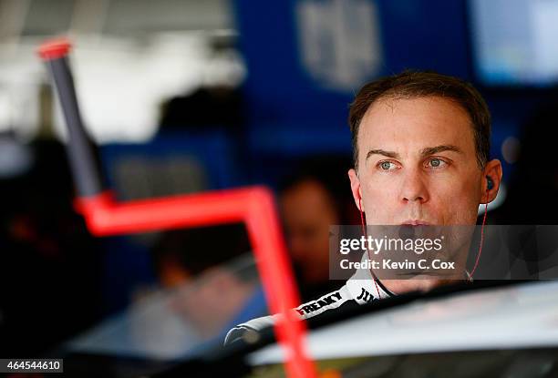 Kevin Harvick, driver of the Jimmy John's Budweiser Chevrolet, stands in the garage during a testing session at Atlanta Motor Speedway on February...