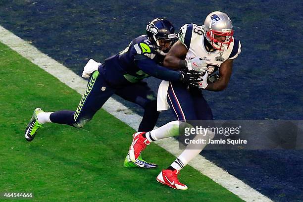 Brandon LaFell of the New England Patriots scores an 11 yard touchdown against Tharold Simon and Earl Thomas of the Seattle Seahawks in the second...