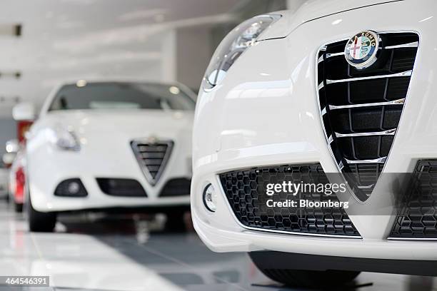 Fiat SpA Alfa Romeo Mito, right, and Giulietta automobiles stand on display inside a GST Co. Showroom in Tokyo, Japan, on Wednesday, Jan. 22, 2014....