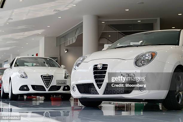 Fiat SpA Alfa Romeo Mito, right, and Giulietta automobiles stand on display inside a GST Co. Showroom in Tokyo, Japan, on Wednesday, Jan. 22, 2014....