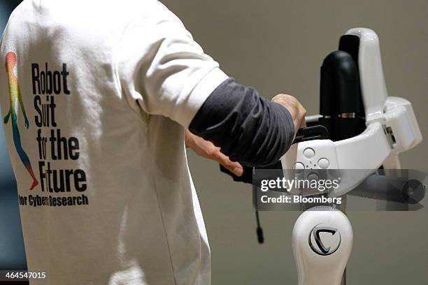 Physiotherapist Masato Hasegawa places Cyberdyne Inc.'s lower-limb model Hybrid Assistive Limb exoskeleton on its stand following a training program...