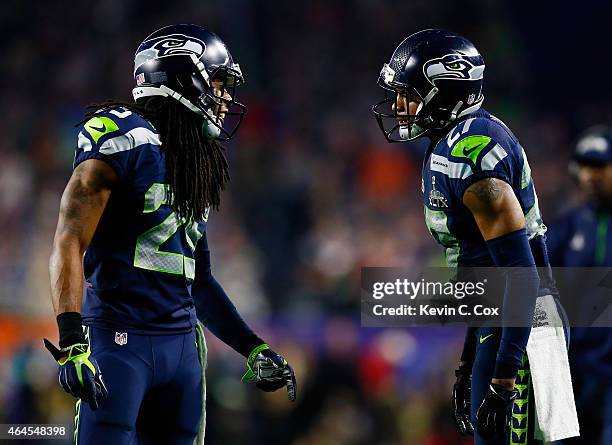 Cornerback Richard Sherman of the Seattle Seahawks reacts with cornerback Tharold Simon of the Seattle Seahawks against the New England Patriots...