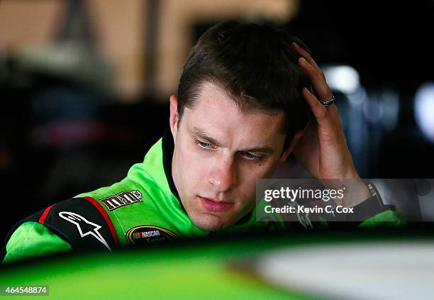 David Ragan, driver of the M&M's Crispy Toyota, stands in the garage during a testing session at Atlanta Motor Speedway on February 26, 2015 in...