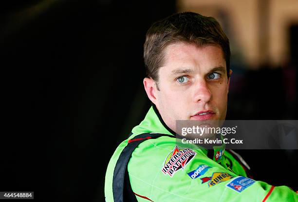 David Ragan, driver of the M&M's Crispy Toyota, exits the car during a testing session at Atlanta Motor Speedway on February 26, 2015 in Hampton,...