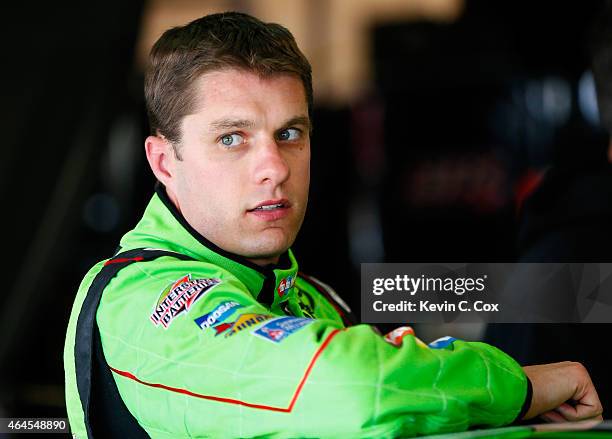 David Ragan, driver of the M&M's Crispy Toyota, exits the car during a testing session at Atlanta Motor Speedway on February 26, 2015 in Hampton,...