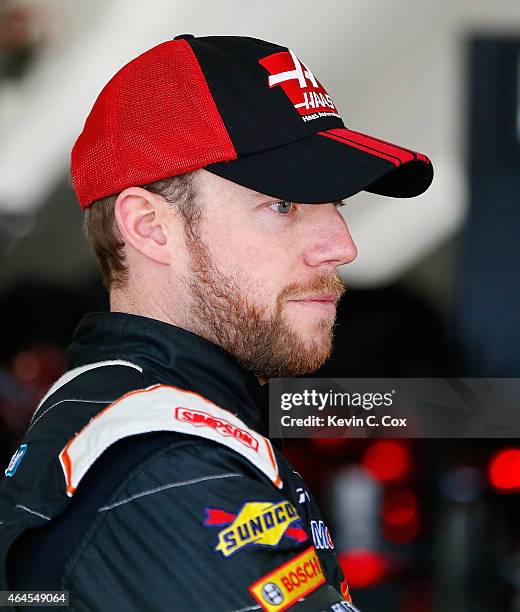 Regan Smith, driver of the Haas Automation Chevrolet, stands in the garage during a testing session at Atlanta Motor Speedway on February 26, 2015 in...