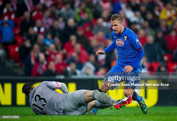 Maxi Lopez of Torino FC duels for the ball with Iago Herrerin of Athletic Club during the UEFA Europa League Round of 32 match between Athletic Club...