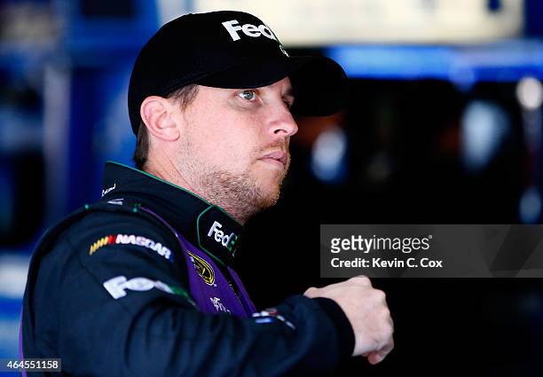 Denny Hamlin, driver of the FedEx Ground Toyota, climbs into his car during a testing session at Atlanta Motor Speedway on February 26, 2015 in...