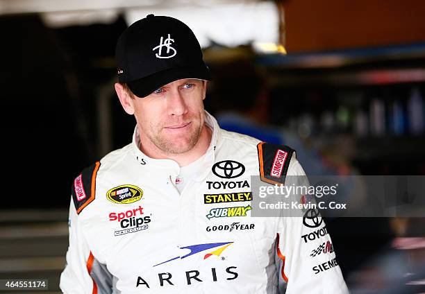 Carl Edwards, driver of the Arris Toyota, stands in the garage during a testing session at Atlanta Motor Speedway on February 26, 2015 in Hampton,...