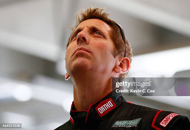 Greg Biffle, driver of the Ortho Ford, stands in the garage during a testing session at Atlanta Motor Speedway on February 26, 2015 in Hampton,...