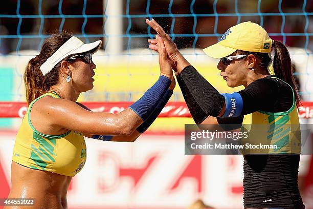 Maria Elisa Antonelli and Juliana da Silva of Brazil celebrate at a match against Jennifer Kessy and Emily Day of the United States during the Brazil...