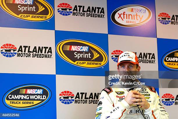 Carl Edwards, driver of the Arris Toyota, speaks to members of the media during a testing session at Atlanta Motor Speedway on February 26, 2015 in...