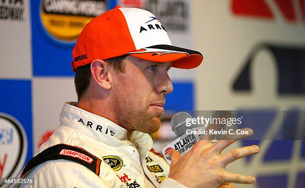 Carl Edwards, driver of the Arris Toyota, speaks to members of the media during a testing session at Atlanta Motor Speedway on February 26, 2015 in...