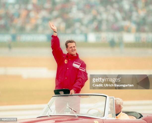 Michael Schumacher in a Ferrari convertible waving during the drivers' parade before the Formula 1 Grand Prix at the Hockenheimring, Germany, 28th...
