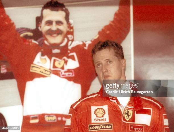 Michael Schumacher in the Ferrari box on the edge of the Formula 1 Grand Prix at the Hockenheimring. In the background Schumacher posters, on August...