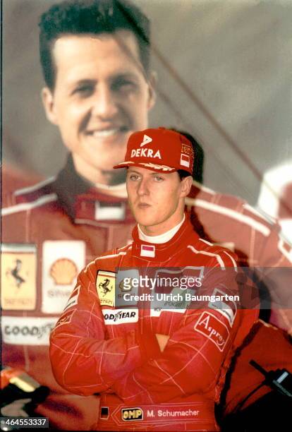 April 27: Michael Schumacher in the Ferrari box on the edge of the Formula 1 Grand Prix at the Nuerburgring. In the background Schumacher posters, on...