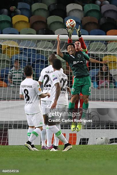 Sporting's forward Junya Tanaka vies with Wolfsburg's goalkeeper Diego Benaglio in action during the UEFA Europa League Round of 32 match between...