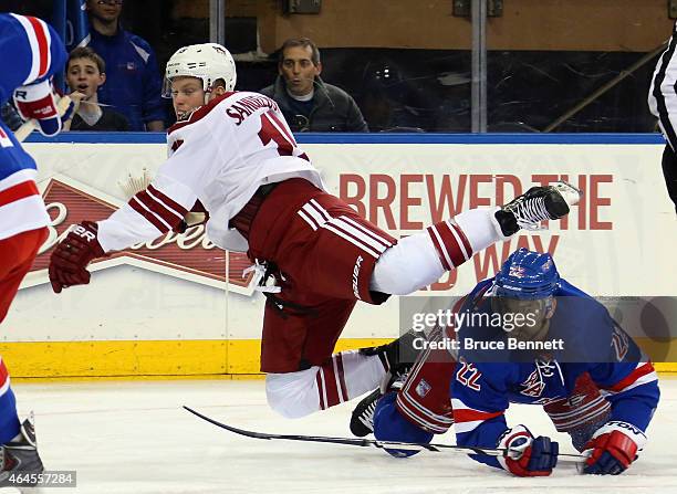 Skating in his first NHL game, Henrik Samuelsson of the Arizona Coyotes is tripped up by Dan Boyle of the New York Rangers at Madison Square Garden...