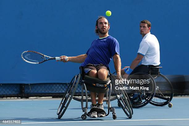 Adam Kellerman of Australia and Joachim Gerard of Belgium in action in their wheelchair doubles semifinal match against Stephane Houdet of France and...