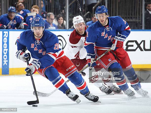 Chris Kreider of the New York Rangers skates with the puck against Joe Vitale of the Arizona Coyotes at Madison Square Garden on February 26, 2015 in...