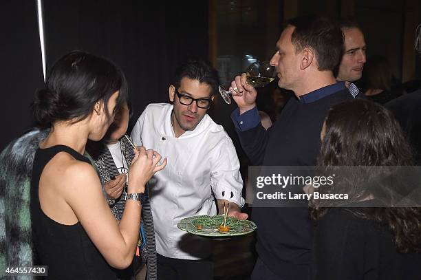 Chef George Mendes serves food during a celebration of The New SAVEUR at Chef George Mendes' soon-to-be opened Lupulo Restaurant on February 26, 2015...