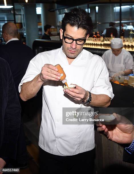 Chef George Mendes prepares an oyster during a celebration of The New SAVEUR at Chef George Mendes soon-to-be opened Lupulo Restaurant on February...