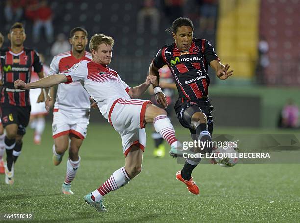 United's Bobby Boswell and Jonathan Mac of Liga Deportiva Alajuelense vie for the ball during the Concacaf Champions League quarterfinal match in...