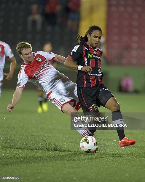 United's Bobby Boswell and Jonathan Mac of Liga Deportiva Alajuelense vie for the ball during the Concacaf Champions League quarterfinal match in...