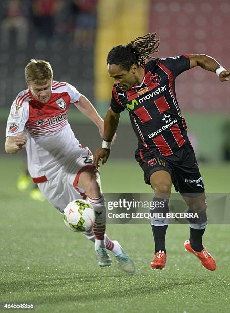 United's Bobby Boswell and Jonathan Mac of Liga Deportiva Alajuelense vie for the ball during the Concacaf Champions League quarterfinal match in...