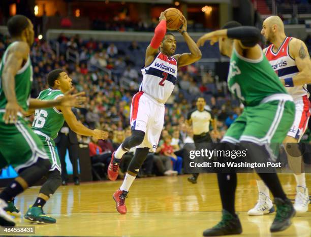 Washington point guard John Wall , center, pass off at the top of the key, Wall earned a triple double as the Boston Celtics defeat the Washington...