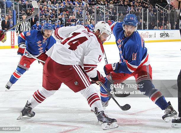 Derick Brassard of the New York Rangers takes a face-off against Joe Vitale of the Arizona Coyotes at Madison Square Garden on February 26, 2015 in...