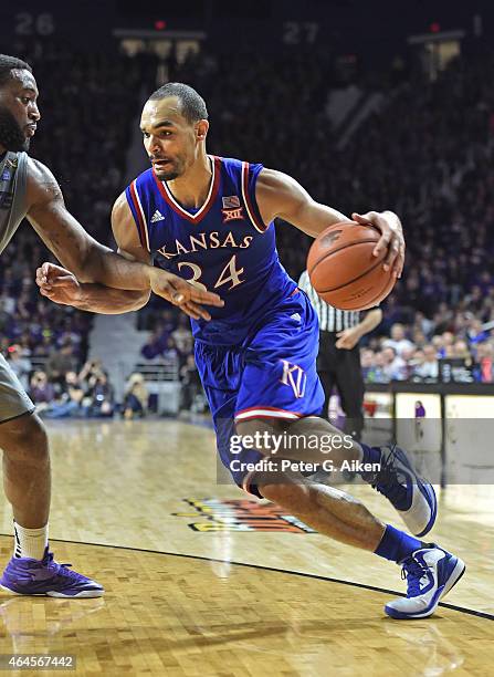 Forward Perry Ellis of the Kansas Jayhawks drives with the ball against forward Thomas Gipson of the Kansas State Wildcats during the first half on...