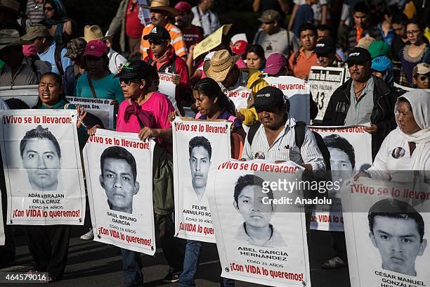 Demonstrators march during a protest in Mexico City, on February 26, 2015 to demand justice for 43 students from Ayotzinapa College who went missing...