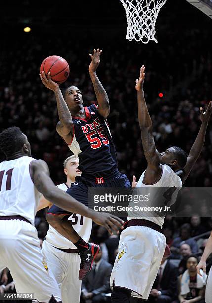 Delon Wright of the Utah Utes puts up two second-half points between Savon Goodman and Gerry Blakes of the Arizona State Sun Devils at the Jon M....