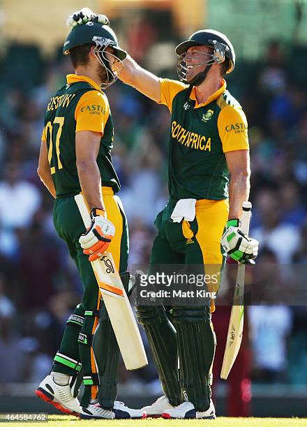 Rilee Rossouw of South Africa celebrates with AB de Villiers after scoring a half century during the 2015 ICC Cricket World Cup match between South...