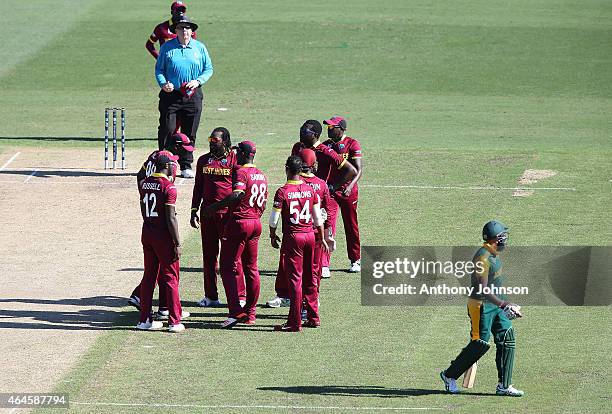 Hashim Amla walks off after being dismissed by Chris Gayle during the 2015 ICC Cricket World Cup match between South Africa and the West Indies at...