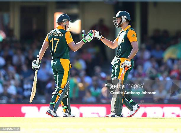 South African batsman Rilee Rossouw congratulates AB De Villiers after scoring 50 during the 2015 ICC Cricket World Cup match between South Africa...