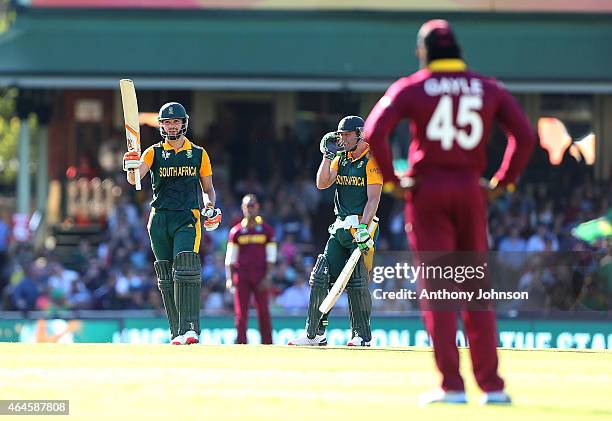 South African batsman Rilee Rossouw celebrates his 50 with AB De Villiers during the 2015 ICC Cricket World Cup match between South Africa and the...