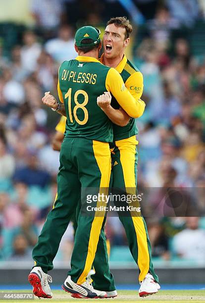 Kyle Abbott of South Africa celebrates with Faf du Plessis after taking the wicket of Chris Gayle of West Indies during the 2015 ICC Cricket World...