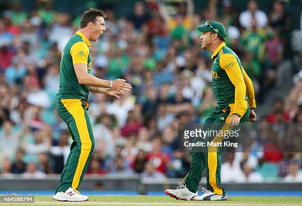 Kyle Abbott of South Africa celebrates with Faf du Plessis after taking the wicket of Chris Gayle of West Indies during the 2015 ICC Cricket World...