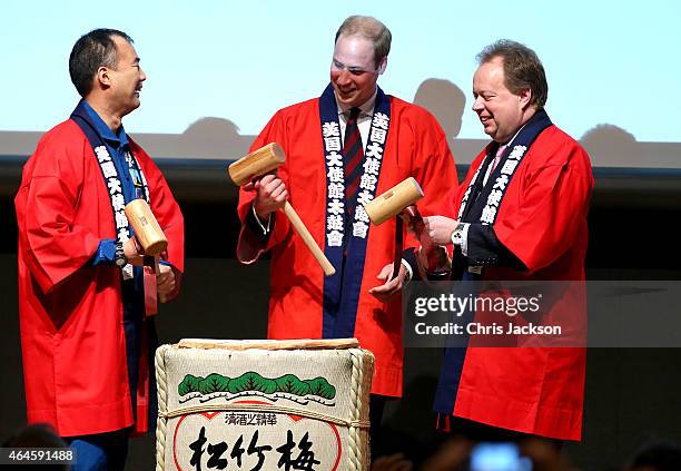 Prince William, Duke of Cambridge waves, dressed in a 'Happi' coat, takes part in a Sake Barrell Breaking Ceremony with Japanese Astronaut Soichi...