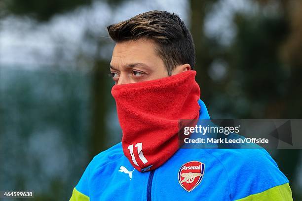 Mesut Ozil of Arsenal wearing a snood pulled up over his face during the Arsenal training session ahead of the UEFA Champions League round of 16...