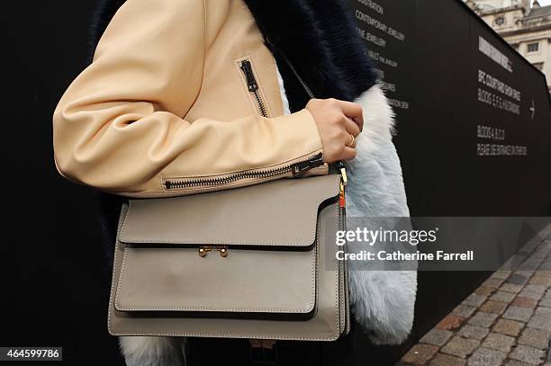 Shini Park a graphic designer, wearing a salmon pink Chloe leather jacket , accessorising her look with an ASOS scarf, and Marni bagduring London...