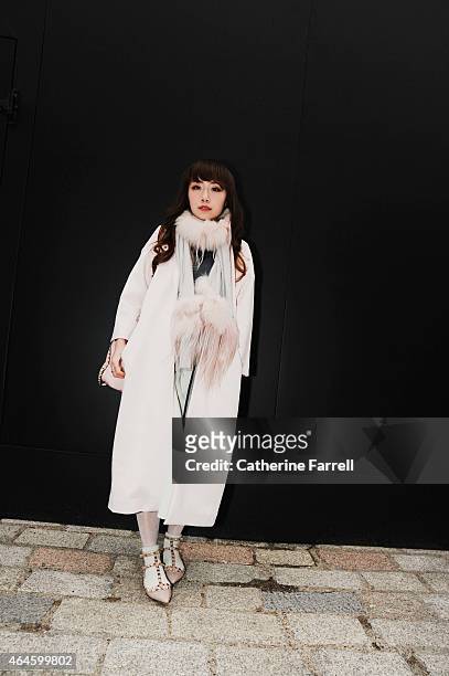 Carrie Kwok stylist and make up artist from Hong Kong, wearing on trend head to toe pale dusky pink; her look comprising a coat by Injury,...