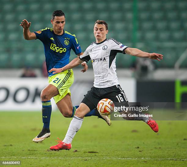 Michal Maslowski and Anwar El Ghazi during the UEFA Europa League round of 32 match between Legia Warszawa and Ajax Amsterdam at the Polish Army...