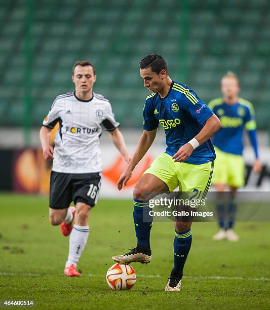 Michal Maslowski and Anwar Al Ghazi during the UEFA Europa League round of 32 match between Legia Warszawa and Ajax Amsterdam at the Polish Army...