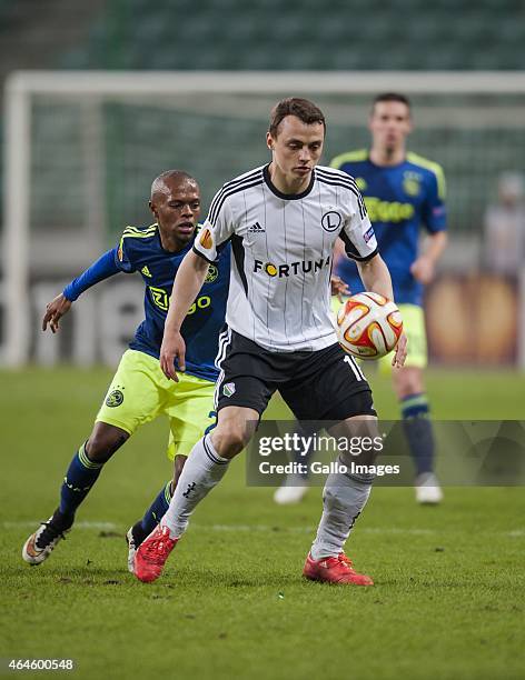 Michal Maslowski and Riechedly Baozer during the UEFA Europa League round of 32 match between Legia Warszawa and Ajax Amsterdam at the Polish Army...