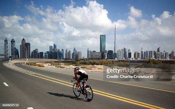 Daniela Ryf of Switzerland competes in the cycle leg of the womens race as she cycles back toward the Dubai city skyline during the Challenge...